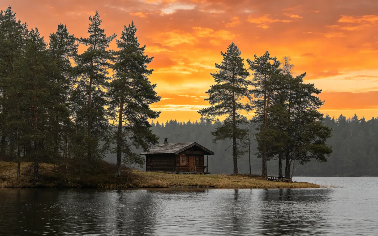 Un cielo gris sobre una cabaña junto al lago repintado como un atardecer — Después